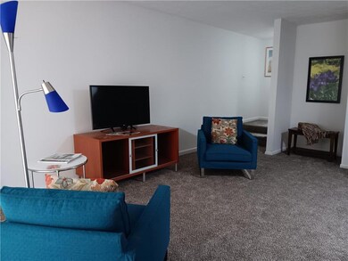 Living room with carpet flooring and baseboards