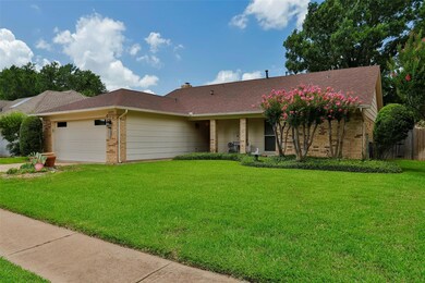 Single story home with a front lawn and a garage