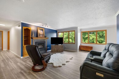 Upstairs to your open, window-full living space with gas fireplace!