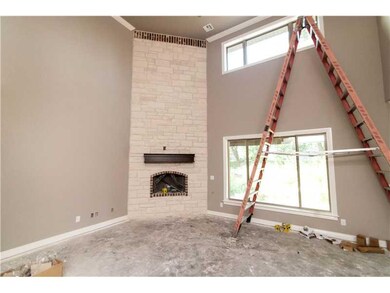 Living Room. Corner stone fireplace, large window and open to kitchen.