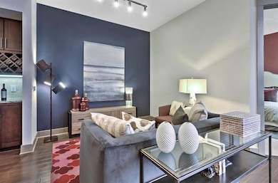 Living room featuring track lighting and dark hard
