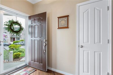Natural light pours into the foyer through the a new, lockable storm door.