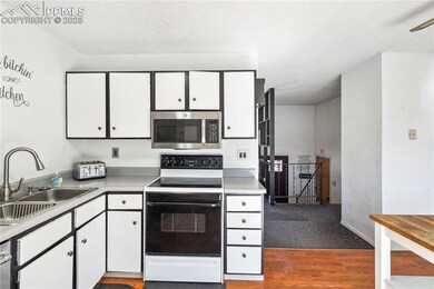 Kitchen with light countertops, stainless steel mi