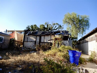View of the rear of the house structure. The existing house is built on the lot line without any setback on this side, which may be grandfathered in for your remodel or rebuild plans. All to be verified by buyer with the City of San Diego.