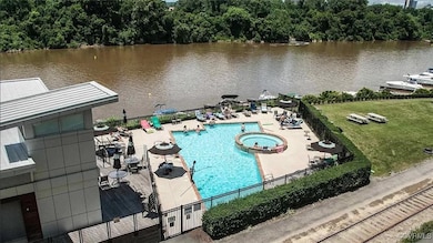 View of swimming pool with a patio, a water view,