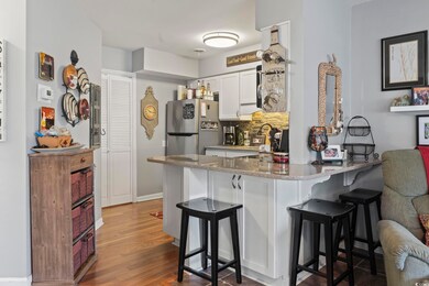 Kitchen featuring kitchen peninsula, white cabinet
