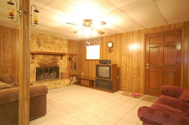 Living room with tile floor and fireplace.