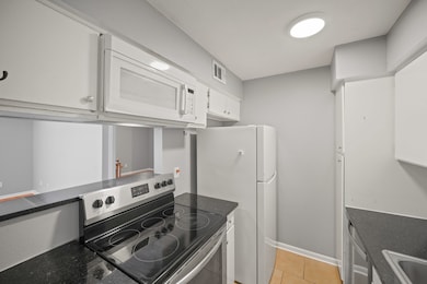 This charming kitchen offers elegant granite count