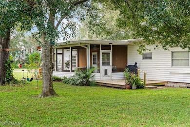 Back of property with a yard