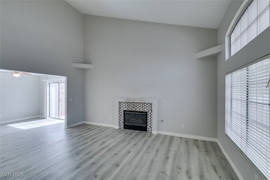 Unfurnished living room featuring high vaulted cei