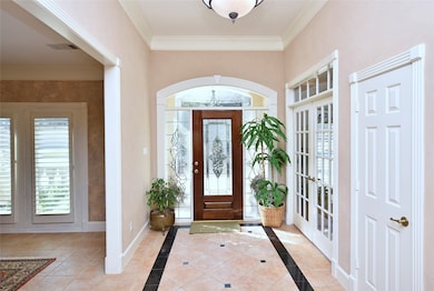 You know what they say about first impressions! This entry will truly make a lasting impression.  As you step through the front door, you are greeted with natural light streaming through the lead glass front door, side lights and transom window. Soaring ceilings, custom crown molding, cased doors, transom windows and 6