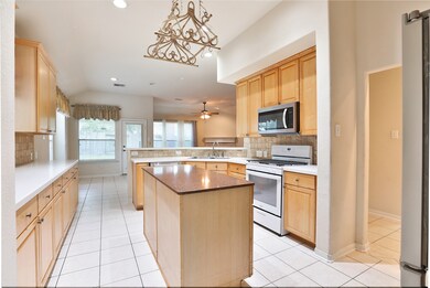 This large kitchen overlooks the breakfast and living rooms offering a breakfast bar, island, and pot rack. The kitchen also features 42
