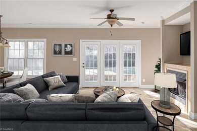 Open living area, full of sunlight with gas logs and french doors