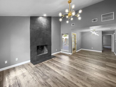 Unfurnished living room featuring a tiled fireplac