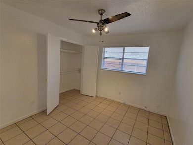 Unfurnished bedroom with a closet, light tile patt