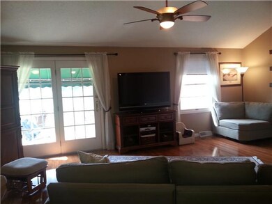 Living Room French doors lead to covered balcony w