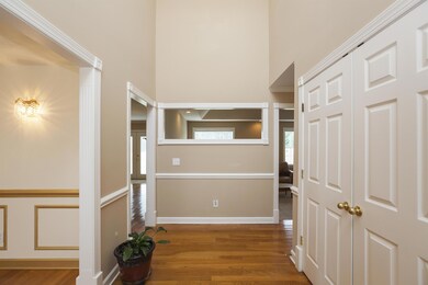 Foyer offers hardwood floors and extra long coat closet!