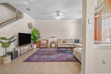 Tiled living room with a ceiling fan, ornamental m