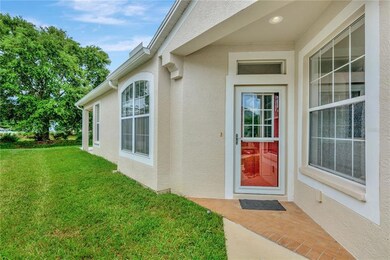 Brick Paver Covered Front Porch - Pretty Green Belt area on Left Side of Villa to Backyard area