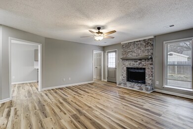 Unfurnished living room with a brick fireplace, vi