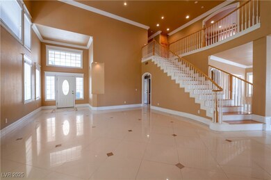 Tiled foyer entrance with a towering ceiling, crow