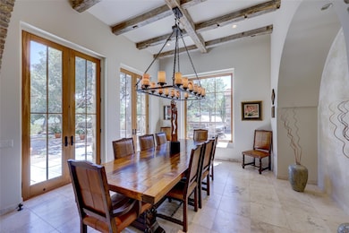 Dining area with beam ceiling, a notable chandeli