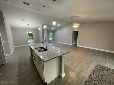 Kitchen with vaulted ceiling, hardwood / wood-styl