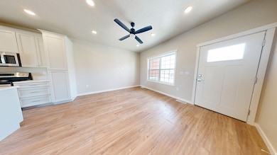 Foyer with ceiling fan, recessed lighting, and light wood-style flooring