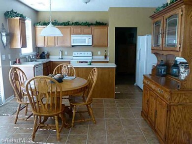 Kitchen. Large breakfast area receives great afternoon light from the back patio glass.