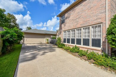 Detached oversized garage with an extended backyard patio.