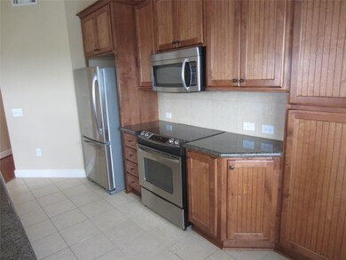 wooden cabinets and stainless steel appliances