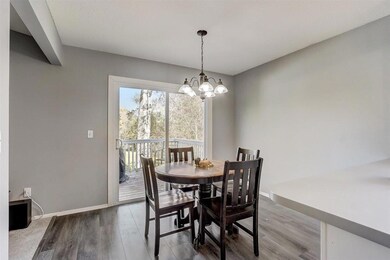 Dining room offers plenty of space for a large table, and a new sliding glass door leading out to the deck.