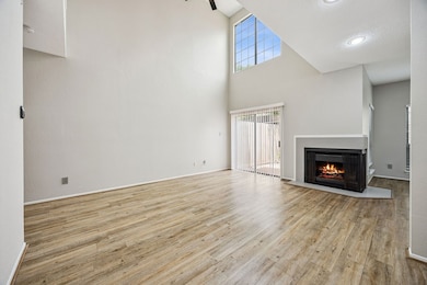 TONS OF LIGHT!! The living room has tall ceilings.