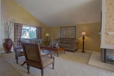 Living room shares a dual sided fireplace with the