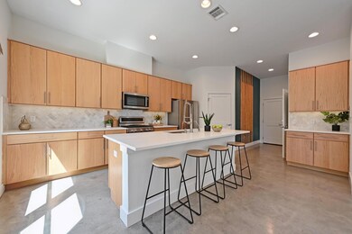 Kitchen featuring tasteful backsplash, concrete f