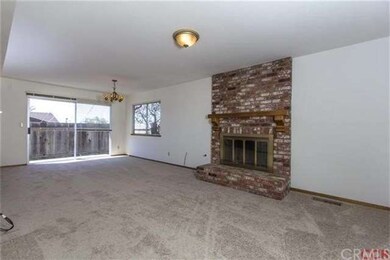 Family room with brick fireplace and dining area.