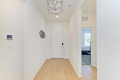 Entrance way with guest bedroom and bathroom to the right.  2 car garage is on the other side of the wall on the left.