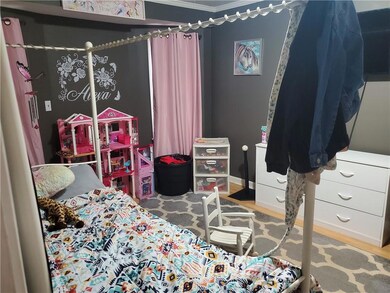 Bedroom with baseboards, wood finished floors, and