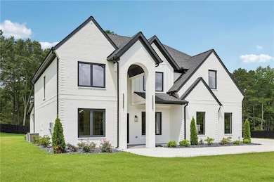 View of front of house featuring brick siding and a shingled roof