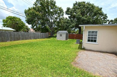 Back of house with shed partially fenced