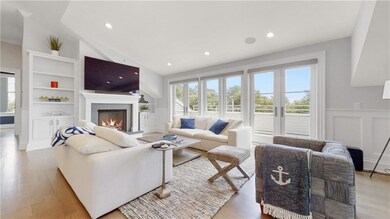 Living room w/ gas fireplace & doors to outdoor sp