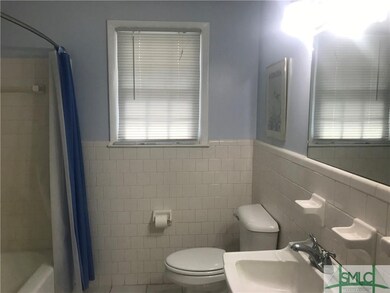 Bathroom features a shower over the tub.