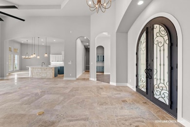 Entrance foyer featuring a notable chandelier, hi