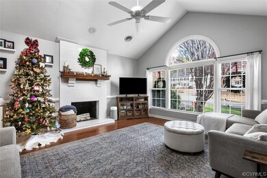 Living room with a brick fireplace, high vaulted c