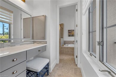 Bathroom featuring backsplash, a relaxing tiled tu