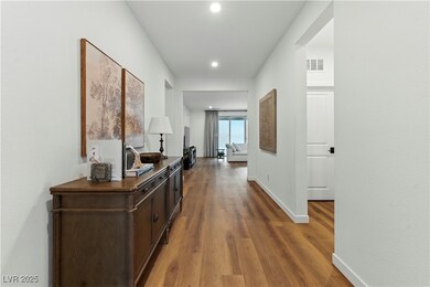 Corridor featuring wood finished floors and recessed lighting