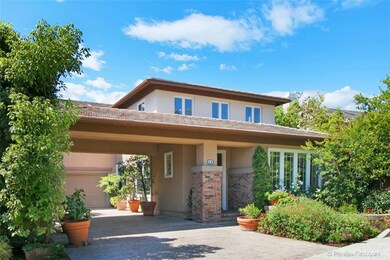 Lush foliage and blossoming trees surround this we