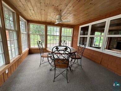 Sunroom / solarium featuring wooden ceiling and ce