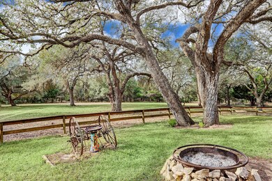 View from the front of the home.  Fire pit and gated yard.