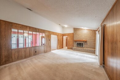 Unfurnished living room featuring vaulted ceiling,
